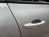 a silver car with a door handle on it ' s side