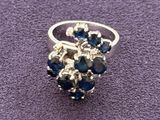 silver ring with blue stones on a purple surface