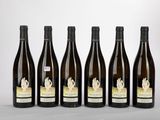 six bottles of wine are lined up in a row