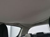 a man sitting in the back seat of a car looking out the window