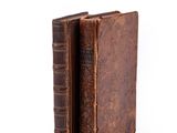 an old book is open on a white surface with a white background