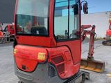 an image of a red construction vehicle parked in a parking lot
