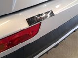a close up of a car ' s tail light with a sticker on it