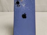 an iphone with a broken screen sitting on top of a table