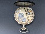 a close up of a pocket watch on a table