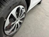 a close up of a tire on a white car