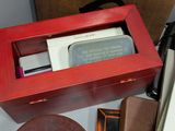 a red box with a knife in it on a table