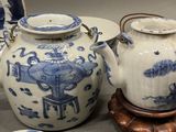 two blue and white vases and a plate on a table