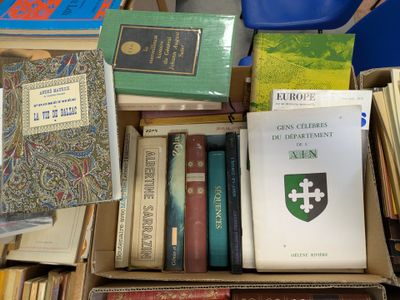 many books in a box on a table