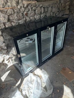 two glass doors that are open on the outside of a building