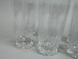 four glasses sitting on a table with a white background