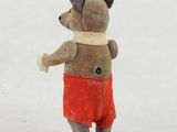 a small stuffed animal that is standing in the snow
