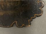 a metal object with a black and gold design on it