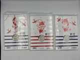 three silver coins are in plastic bags on a white surface