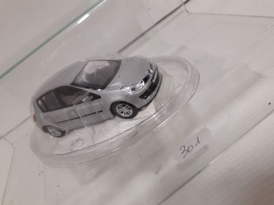 a small toy car in a clear container on a table