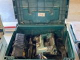a green tool box with tools in it on a table