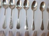 a lot of silver spoons and forks on the table