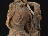 statue of a man holding a piece of wood with a bird on top of it