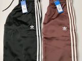 two pairs of adidas track pants with tags on them