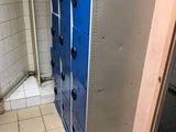 a blue locker in the middle of a bathroom
