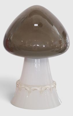 a brown mushroom shaped object on a white pedestal