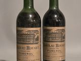 two bottles of wine sitting next to each other on top of a table