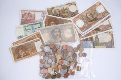 a bag full of different foreign currency on a table