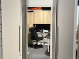 a view of an office from the hallway of the room