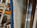 a white refrigerator sitting in a warehouse next to a ladder