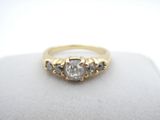 a close up of a diamond ring on a white surface