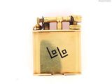 a gold lighter with the word lee written on it