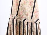 skirt hanging on a hanger on a white wall with a black and white striped skirt hanging on a hanger on a white wall with a black and white wall