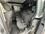two seats in the back of a van with a bag in the passenger seat
