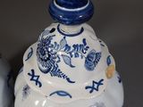 two blue and white vases sitting next to each other