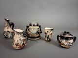 several pieces of pottery are displayed on a gray surface