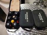 two cases that have balls in them on a table