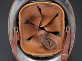a helmet that has a brown leather cover on it