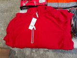 a red jacket and other items on the floor