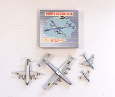 five model airplanes on the wall next to a book