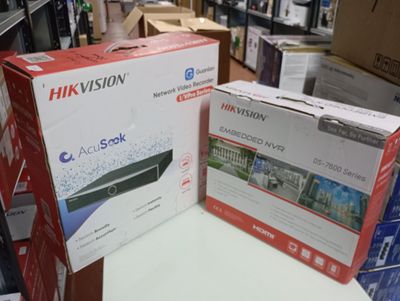 two boxes of hikvision products sit on a table in a store