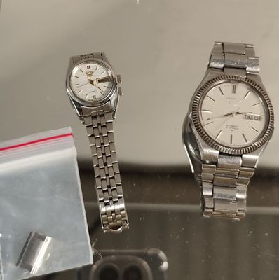 deux montres posées l'une à côté de l'autre sur une table