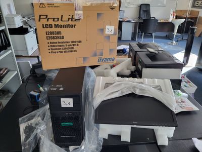 a computer monitor sitting on top of a desk in a room