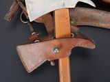 an old axe with a leather sheath on a black background