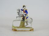a figurine of a man riding on a horse