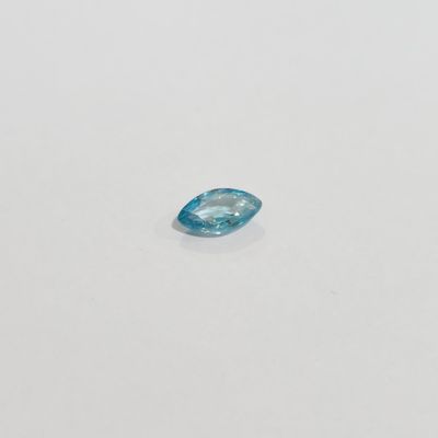 a blue topazte gems on a white surface