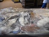 a pile of shoes in a plastic bag on a table