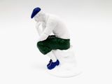 figurine of a man sitting on a toilet with his hand on his chin