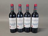 three bottles of red wine sitting on top of a table