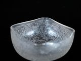 a close up of a glass object on a black background