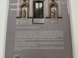 the back cover of a book with a picture of a building in the background